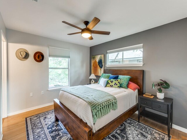 1705 Adriane Dr, Austin, TX 78721 - bedroom with multiple windows, wood finished floors, baseboards, and ceiling fan