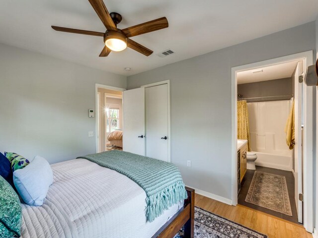 1705 Adriane Dr, Austin, TX 78721 - bedroom with light wood-style flooring, ensuite bathroom, baseboards, ceiling fan, and a closet