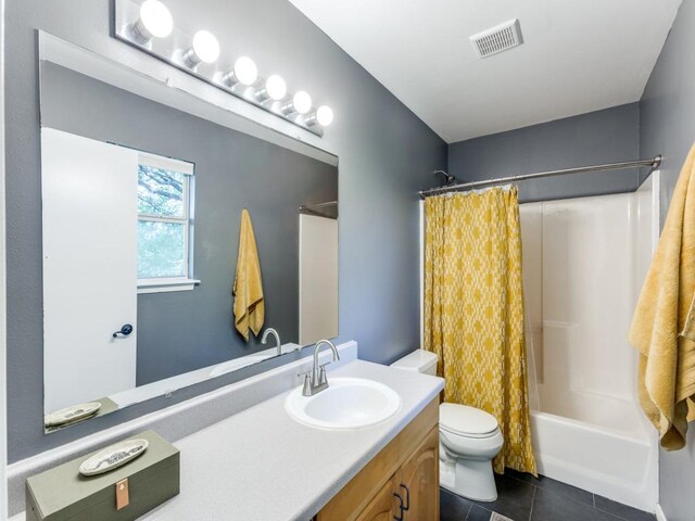 1705 Adriane Dr, Austin, TX 78721 - bathroom with vanity, toilet, tile patterned flooring, and shower / tub combo with curtain