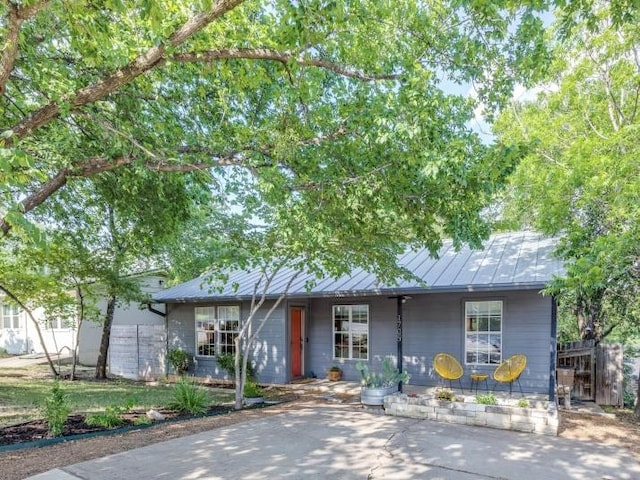 1705 Adriane Dr, Austin, TX 78721 - single story home featuring a standing seam roof, metal roof, and a porch