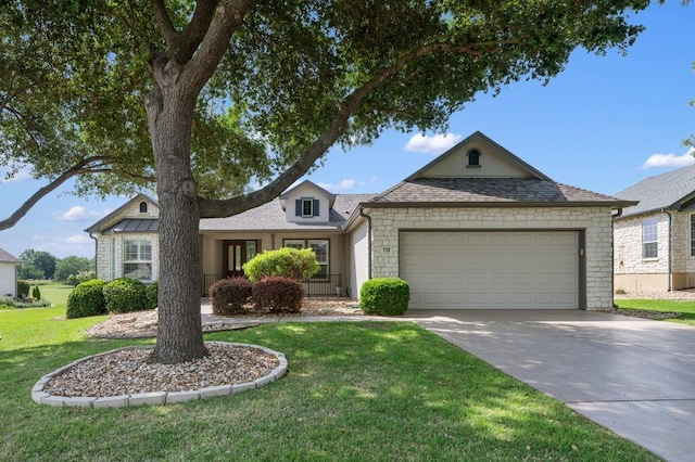 110 Chuckwagon Trl, Georgetown, TX 78633 - view of front of home with an attached garage, a front lawn, driveway, stone siding, and roof with shingles