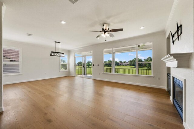 110 Chuckwagon Trl, Georgetown, TX 78633 - unfurnished living room with a ceiling fan, a glass covered fireplace, baseboards, recessed lighting, and wood finished floors