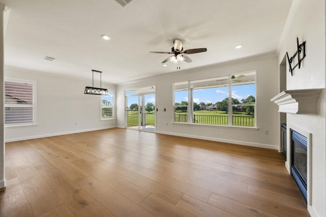 110 Chuckwagon Trl, Georgetown, TX 78633 - unfurnished living room featuring ceiling fan, a glass covered fireplace, recessed lighting, wood finished floors, and ornamental molding