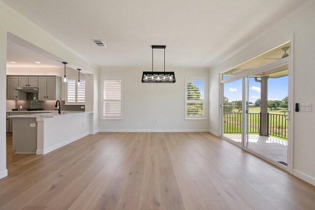 110 Chuckwagon Trl, Georgetown, TX 78633 - unfurnished dining area featuring ornamental molding, light wood finished floors, healthy amount of natural light, and baseboards