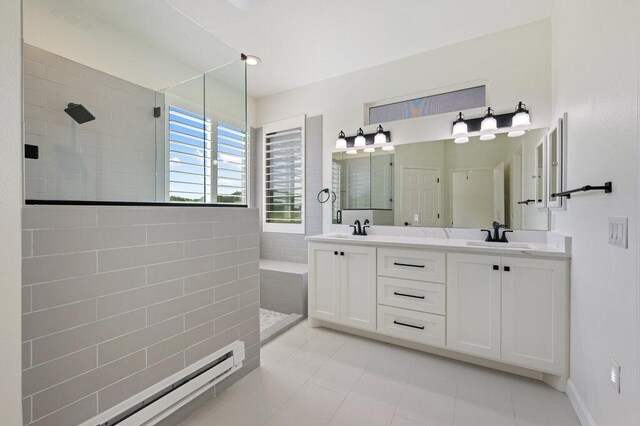 110 Chuckwagon Trl, Georgetown, TX 78633 - bathroom with walk in shower, double vanity, tile patterned flooring, and baseboard heating