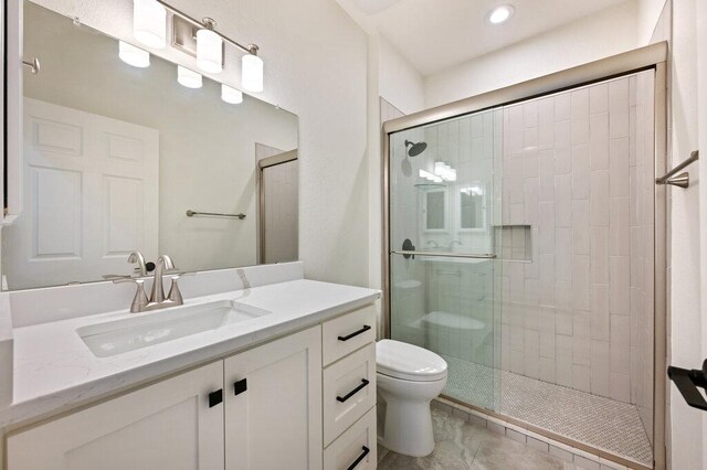 110 Chuckwagon Trl, Georgetown, TX 78633 - bathroom with toilet, vanity, a tile shower, and recessed lighting