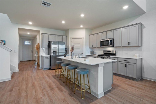 13705 Mc Arthur Dr, Manor, TX 78653 - kitchen with gray cabinetry, stainless steel appliances, a sink, backsplash, and recessed lighting