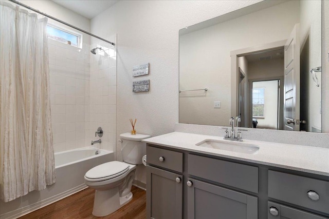 13705 Mc Arthur Dr, Manor, TX 78653 - full bath with wood finished floors, toilet, vanity, and shower / bath combo