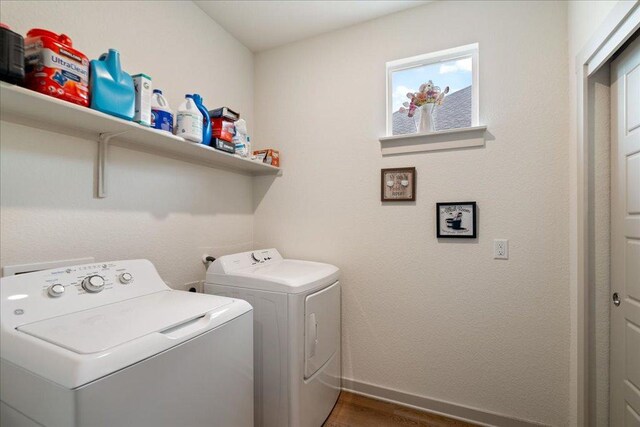 13705 Mc Arthur Dr, Manor, TX 78653 - laundry room with independent washer and dryer, wood finished floors, and baseboards