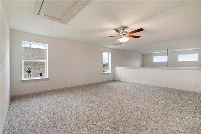 13705 Mc Arthur Dr, Manor, TX 78653 - unfurnished room with attic access, plenty of natural light, carpet floors, and baseboards