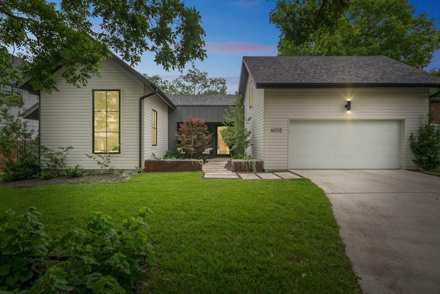 6202 Nasco Dr, Austin, TX 78757 - view of front of property featuring a garage, driveway, a lawn, and roof with shingles