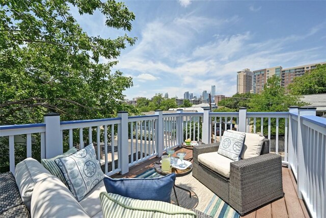 1169 Curve St, Austin, TX 78702 - wooden terrace featuring a city view and an outdoor living space