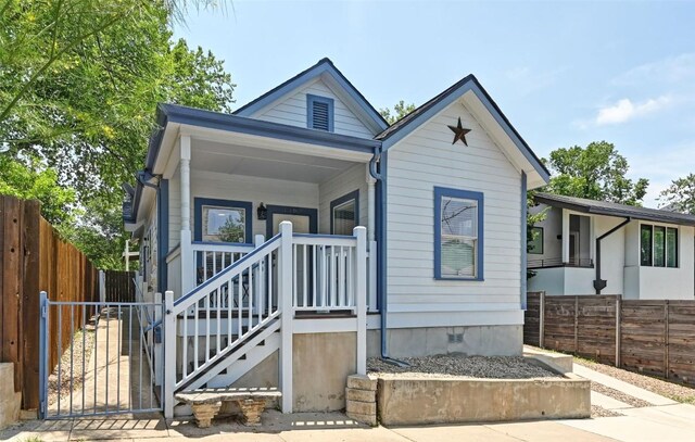 1169 Curve St, Austin, TX 78702 - shotgun-style home featuring a gate