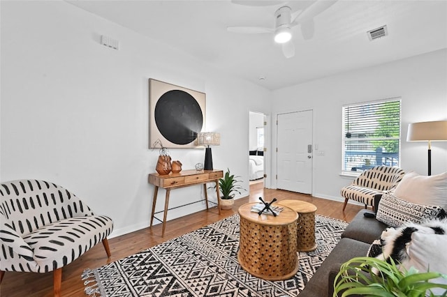 1169 Curve St, Austin, TX 78702 - living area with ceiling fan, wood finished floors, and baseboards