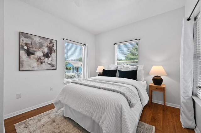 1169 Curve St, Austin, TX 78702 - bedroom featuring multiple windows, wood finished floors, and baseboards