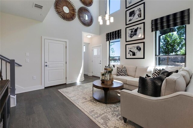 12109 Maypole Bnd, Austin, TX 78717 - living area featuring dark wood-style floors, healthy amount of natural light, baseboards, stairway, and a high ceiling