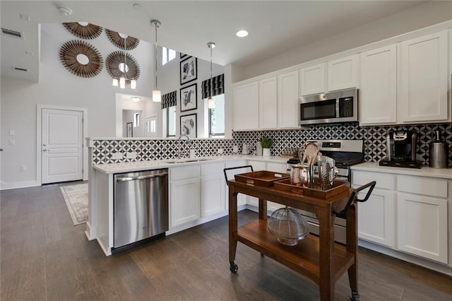 12109 Maypole Bnd, Austin, TX 78717 - kitchen featuring stainless steel appliances, a sink, decorative backsplash, white cabinetry, and recessed lighting
