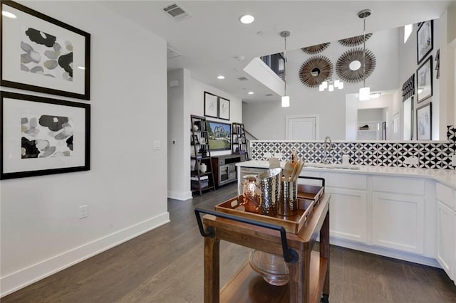 12109 Maypole Bnd, Austin, TX 78717 - interior space featuring a sink, white cabinetry, dark wood finished floors, light countertops, and tasteful backsplash