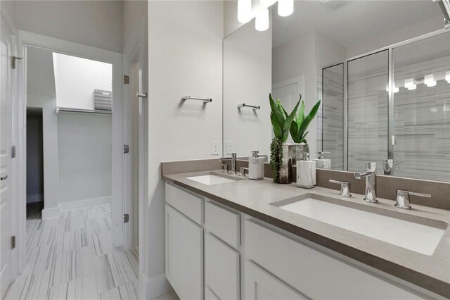 12109 Maypole Bnd, Austin, TX 78717 - full bathroom with double vanity, a shower stall, and baseboards