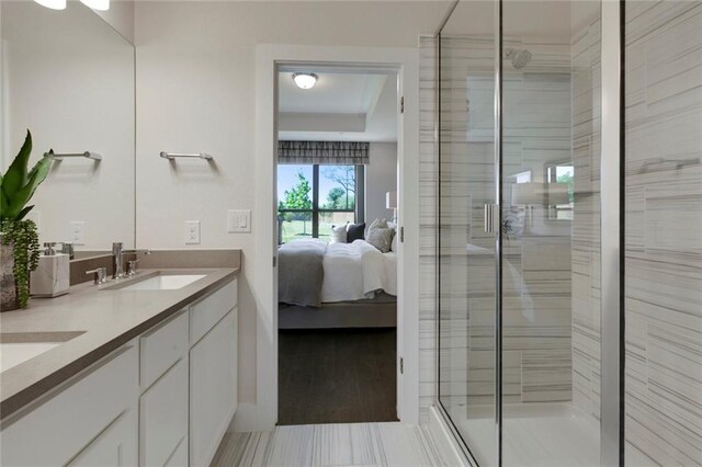 12109 Maypole Bnd, Austin, TX 78717 - bathroom featuring a stall shower, ensuite bathroom, double vanity, and a tray ceiling