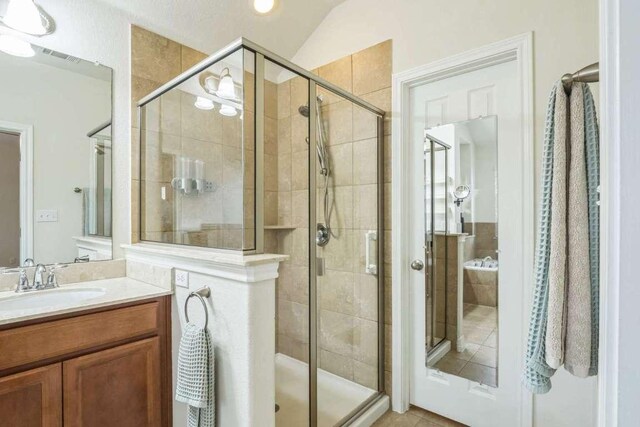 340 Beretta Cir, Georgetown, TX 78628 - bathroom featuring vanity, a shower stall, and tile patterned floors