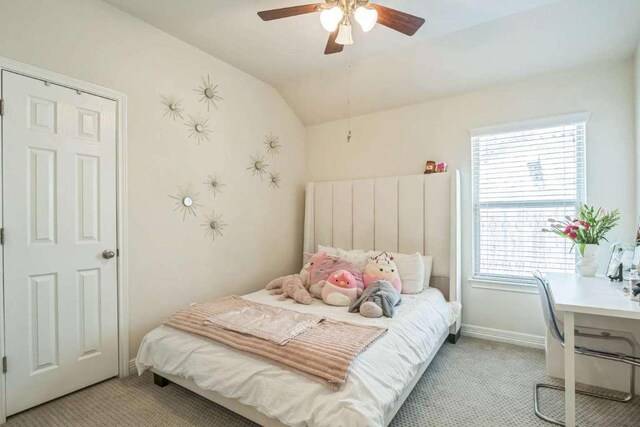 340 Beretta Cir, Georgetown, TX 78628 - bedroom with light carpet, lofted ceiling, a ceiling fan, and baseboards