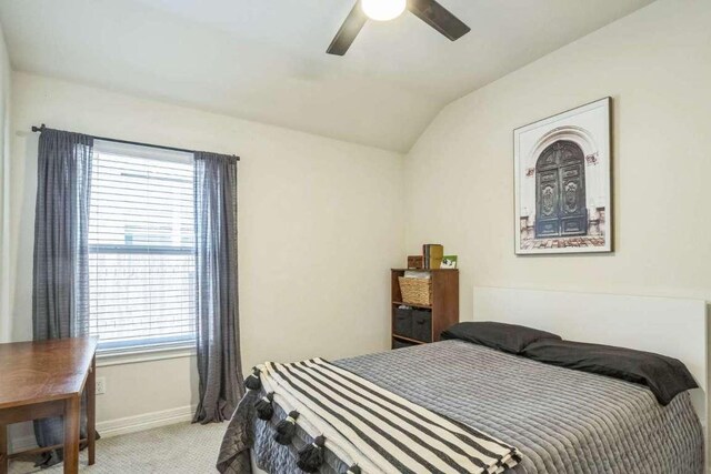 340 Beretta Cir, Georgetown, TX 78628 - bedroom with light carpet, vaulted ceiling, baseboards, and a ceiling fan