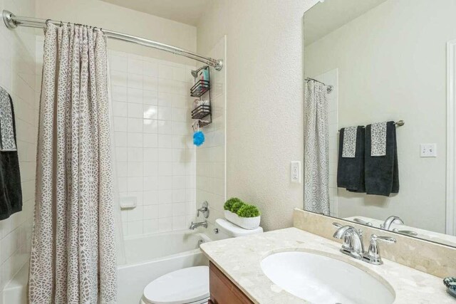 340 Beretta Cir, Georgetown, TX 78628 - bathroom featuring vanity, shower / bath combo, and toilet