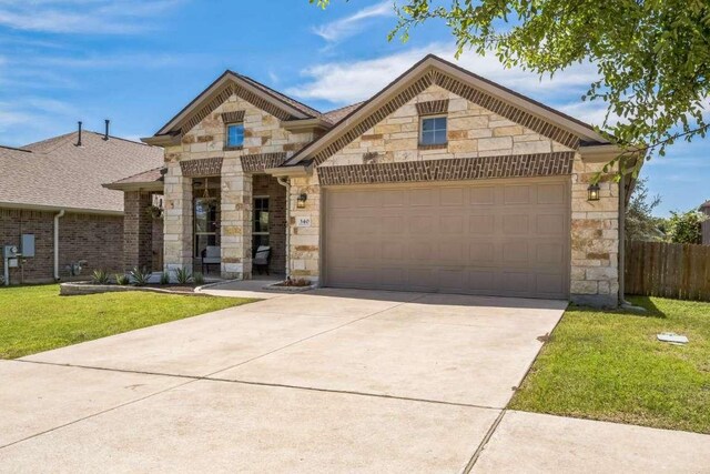 340 Beretta Cir, Georgetown, TX 78628 - french provincial home with stone siding, concrete driveway, and an attached garage