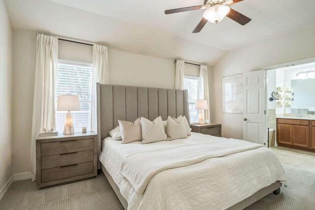 340 Beretta Cir, Georgetown, TX 78628 - bedroom with multiple windows, vaulted ceiling, ensuite bath, baseboards, and a ceiling fan