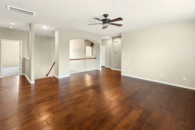 7420 Jaborandi Dr, Austin, TX 78739 - empty room featuring ceiling fan, dark wood finished floors, arched walkways, baseboards, and recessed lighting