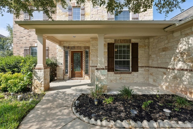 7420 Jaborandi Dr, Austin, TX 78739 - property entrance featuring covered porch, stone siding, and brick siding