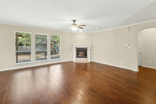 7420 Jaborandi Dr, Austin, TX 78739 - unfurnished living room with a ceiling fan, arched walkways, dark wood finished floors, ornamental molding, and baseboards