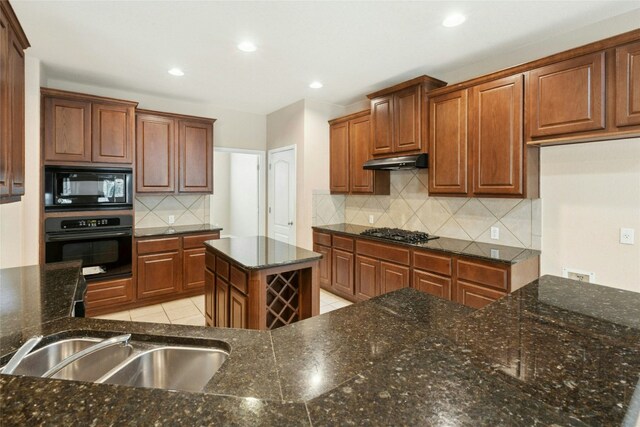 7420 Jaborandi Dr, Austin, TX 78739 - kitchen with black appliances, under cabinet range hood, backsplash, recessed lighting, and dark stone counters