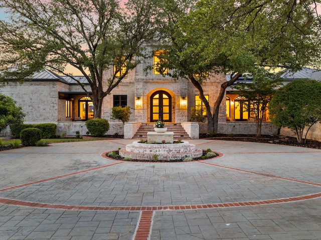 15902 Soleil Ct, Austin, TX 78734 - view of front of house featuring stone siding, curved driveway, and french doors