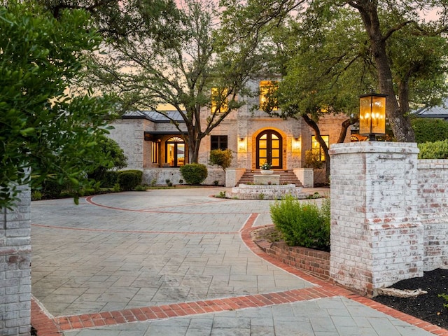 15902 Soleil Ct, Austin, TX 78734 - view of front facade with curved driveway and stone siding