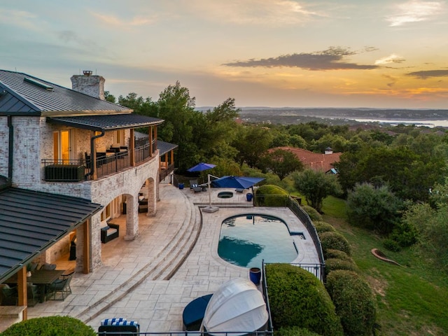 15902 Soleil Ct, Austin, TX 78734 - pool at dusk featuring a patio area, an outdoor pool, and an outbuilding