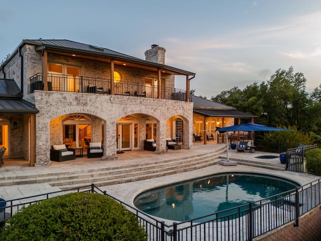 15902 Soleil Ct, Austin, TX 78734 - rear view of house with an outdoor hangout area, a balcony, a standing seam roof, and a patio area