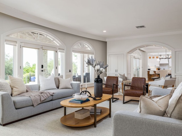 15902 Soleil Ct, Austin, TX 78734 - living room with ornamental molding, arched walkways, a chandelier, and recessed lighting