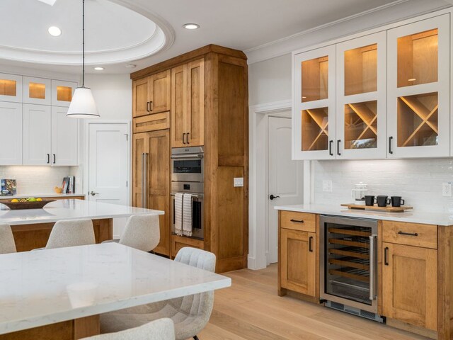 15902 Soleil Ct, Austin, TX 78734 - kitchen with wine cooler, a kitchen bar, double oven, glass insert cabinets, and recessed lighting