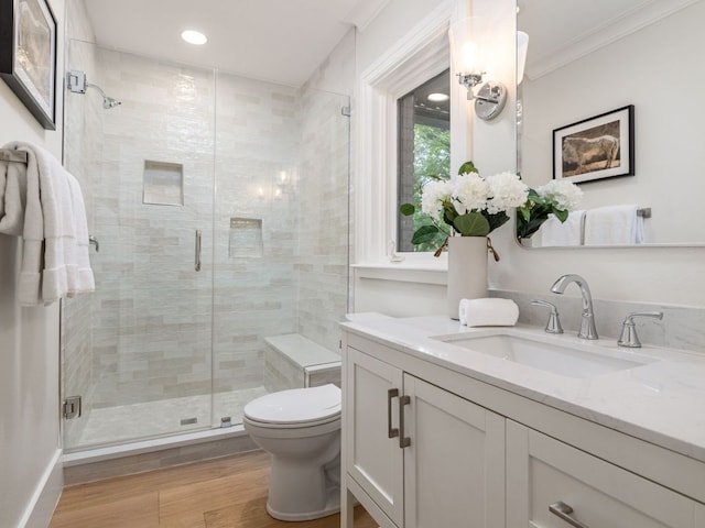 15902 Soleil Ct, Austin, TX 78734 - full bath with vanity, toilet, a stall shower, crown molding, and wood finished floors