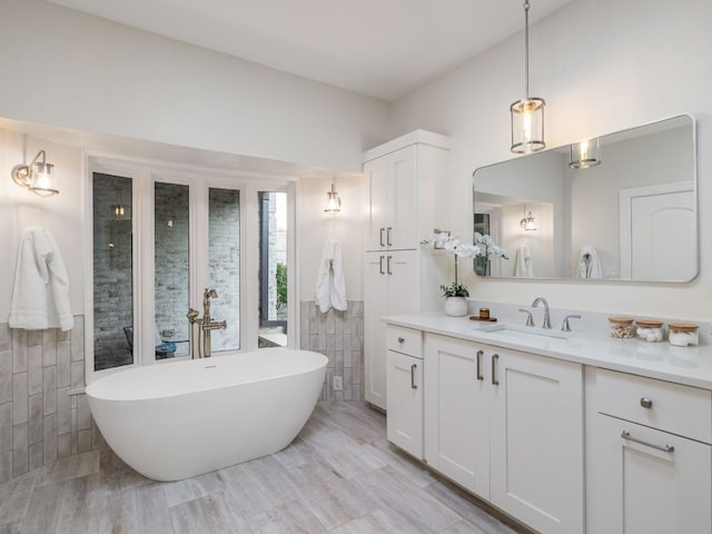 15902 Soleil Ct, Austin, TX 78734 - bathroom featuring tile walls, vanity, and a soaking tub