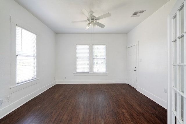 1205 E 12th St, Austin, TX 78702 - unfurnished room with dark wood-type flooring, a ceiling fan, and baseboards