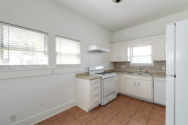 1205 E 12th St, Austin, TX 78702 - kitchen featuring white appliances, a sink, extractor fan, light countertops, and backsplash