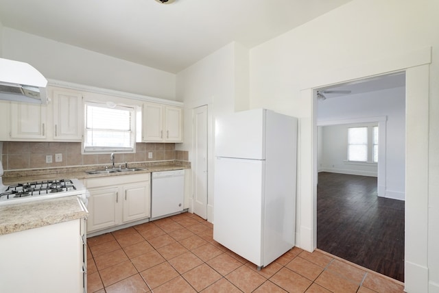 1205 E 12th St, Austin, TX 78702 - kitchen featuring white appliances, a sink, light countertops, backsplash, and light tile patterned floors