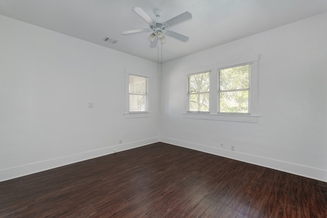 1205 E 12th St, Austin, TX 78702 - spare room featuring baseboards, dark wood-type flooring, and ceiling fan