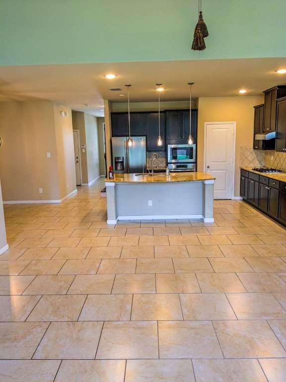 1226 Hidden Cave Dr, New Braunfels, TX 78132 - kitchen featuring stainless steel appliances, tasteful backsplash, range hood, a kitchen island with sink, and recessed lighting