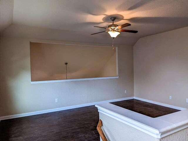 1226 Hidden Cave Dr, New Braunfels, TX 78132 - unfurnished room with vaulted ceiling, a ceiling fan, dark wood-style flooring, and baseboards