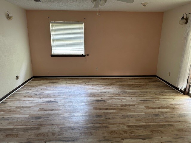1412 Ocotilla Dr, Marble Falls, TX 78654 - unfurnished room featuring wood finished floors and a ceiling fan