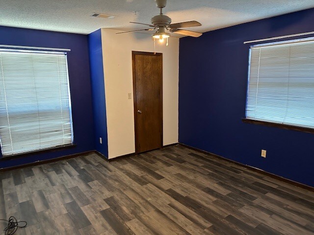 1412 Ocotilla Dr, Marble Falls, TX 78654 - spare room featuring a ceiling fan, dark wood-type flooring, and baseboards